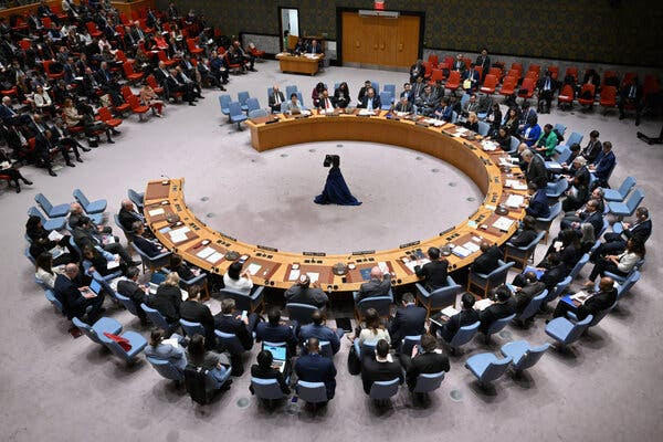 A large room with a desk and chairs set in a near circle.