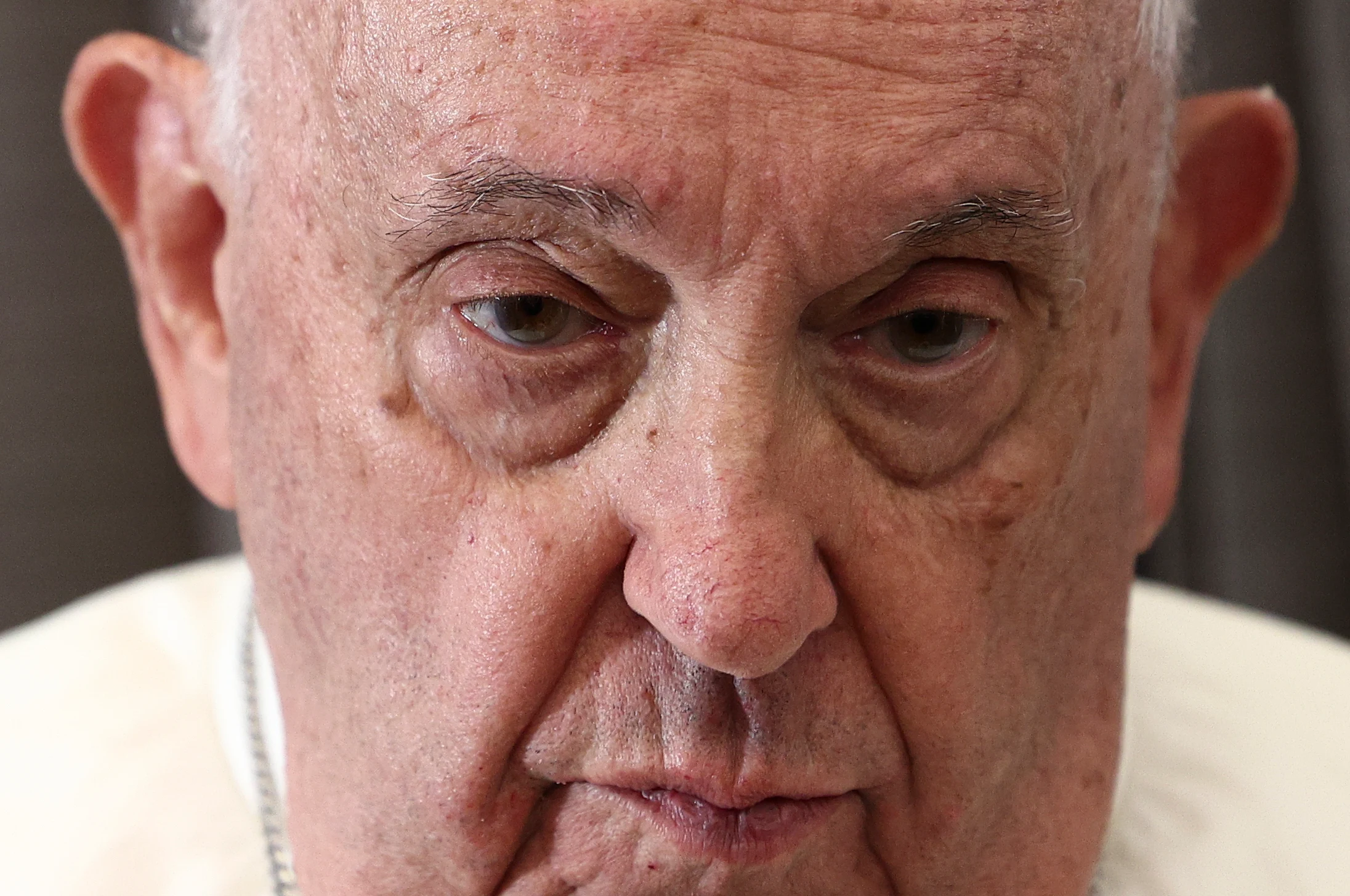 Pope Francis attends a news conference aboard the papal plane on his flight back after his 12-day journey across Southeast Asia and Oceania on Friday. (Guglielmo Mangiapane/Pool Photo via AP).