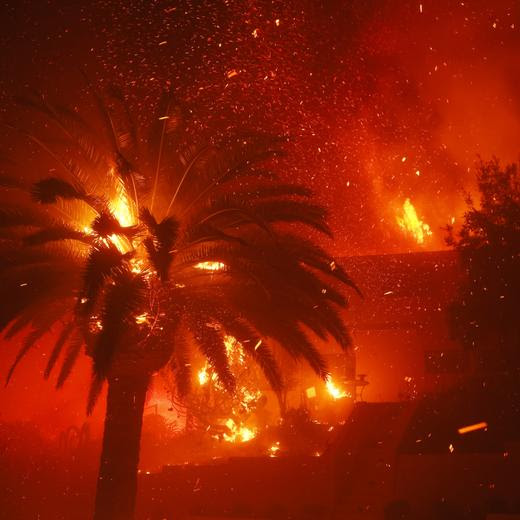 The Palisades Fire burns trees and homes in the Pacific Palisades neighborhood of Los Angeles, Tuesday, Jan. 7, 2025. (AP Photo/Etienne Laurent)