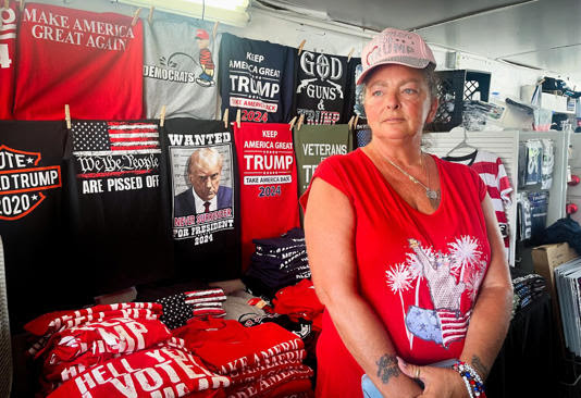 Lori Sarver stands at a roadside Trump merchandise store, where she bought numerous T-shirts. ((Noah Goldberg / Los Angeles Times))