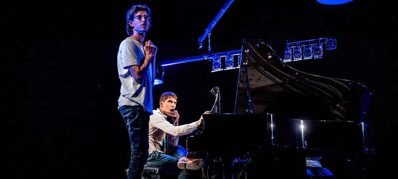 A man playing a grand piano