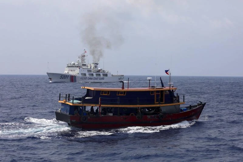 A Philippine supply boat and a Chinese coast guard ship in the South China Sea, October 2023