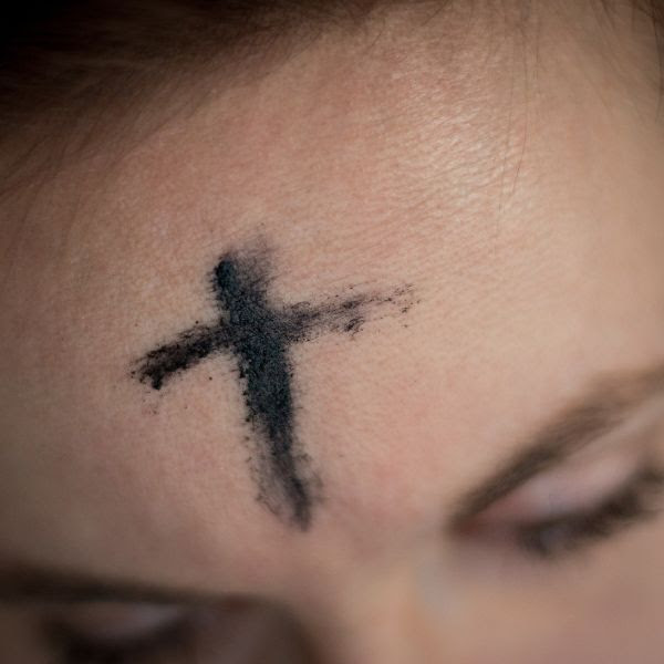 Close-up of ash cross on a person's forehead