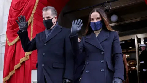 Getty Images Hunter (left) and sister Ashley wave as they arrive at their father's presidential inauguration
