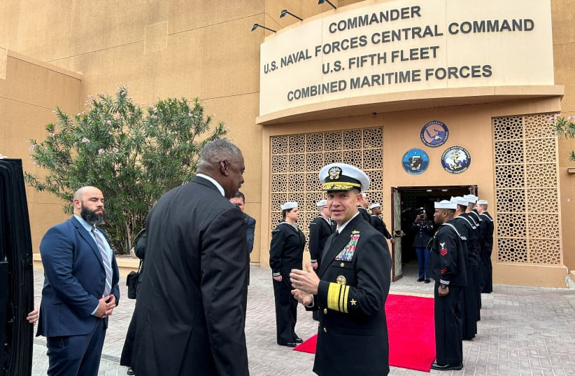 U.S. Defense Secretary Lloyd Austin is greeted by U.S. Navy Vice Admiral Brad Cooper at Navy's Fifth Fleet headquarters in Manama, Bahrain, December 19, 2023. (photo credit: REUTERS/PHIL STEWART)
