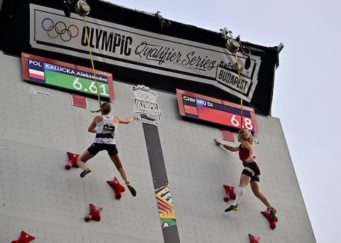 Poland's Aleksandra Kalucka and China's di NIU on a climbing wall