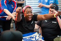 female veteran cheering after a successful lift during weightlifting competition
