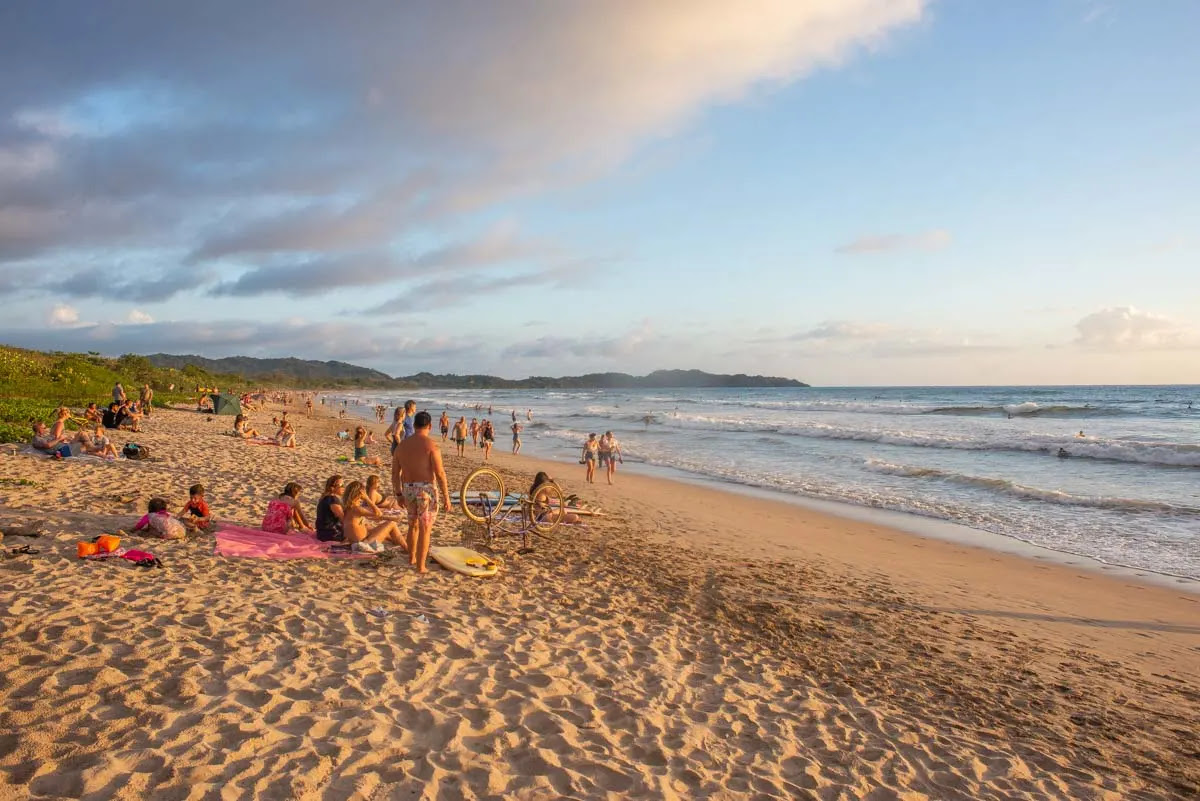 People sitting on the beach at norht Playa Guiones