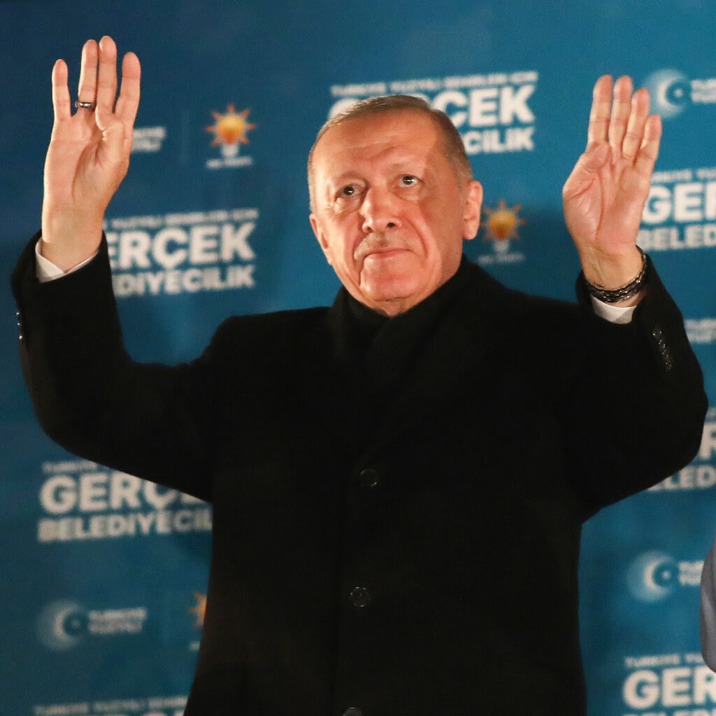 Recep Tayyip Erdogan waves his hands.