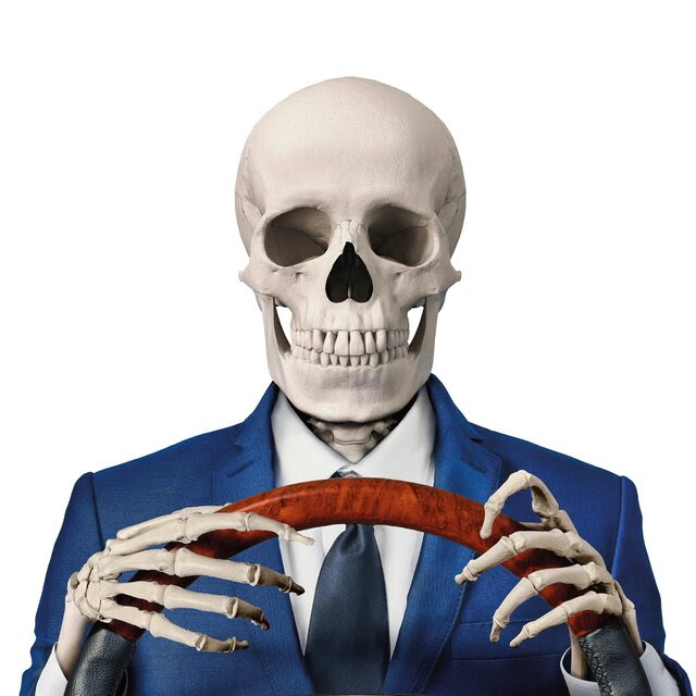 A photo illustration of a skeleton in a suit driving a car.