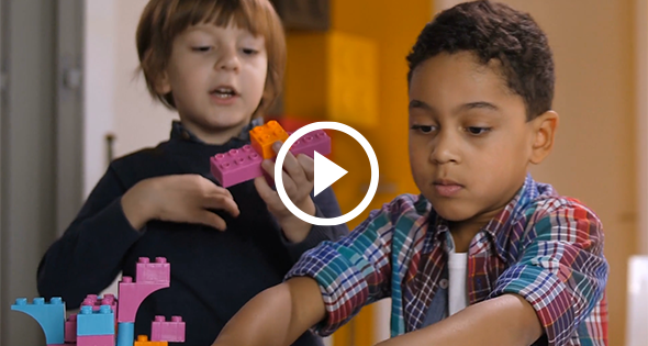 Two preschool age children playing with blocks