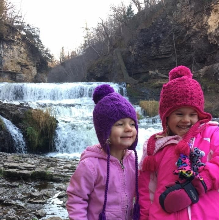 Two children at a waterfall.