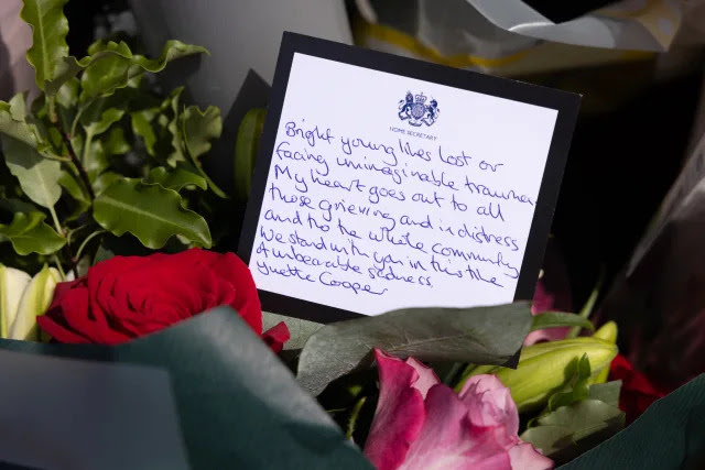 A message in a bouquet of flowers from Home Secretary Yvette Cooper near the scene in Hart Street, Southport, where two children died and nine were injured in a 