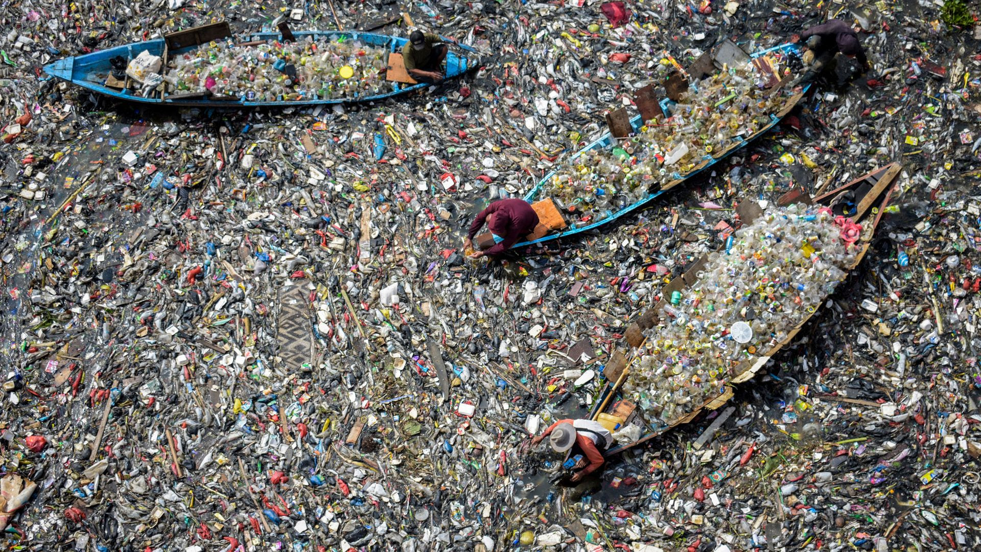 
                                People use boats to collect waste plastic from the Citarum River in Bandung, Indonesia 
                            