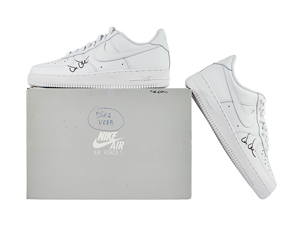 A pair of all-white Nike Air Force 1 Low '07 sneakers exclusively signed by seven-time GRAMMY winner Andre Dr. Dre Young