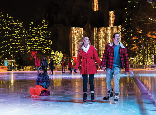 Two adults and one child ice skating at Canada's Wonderland.