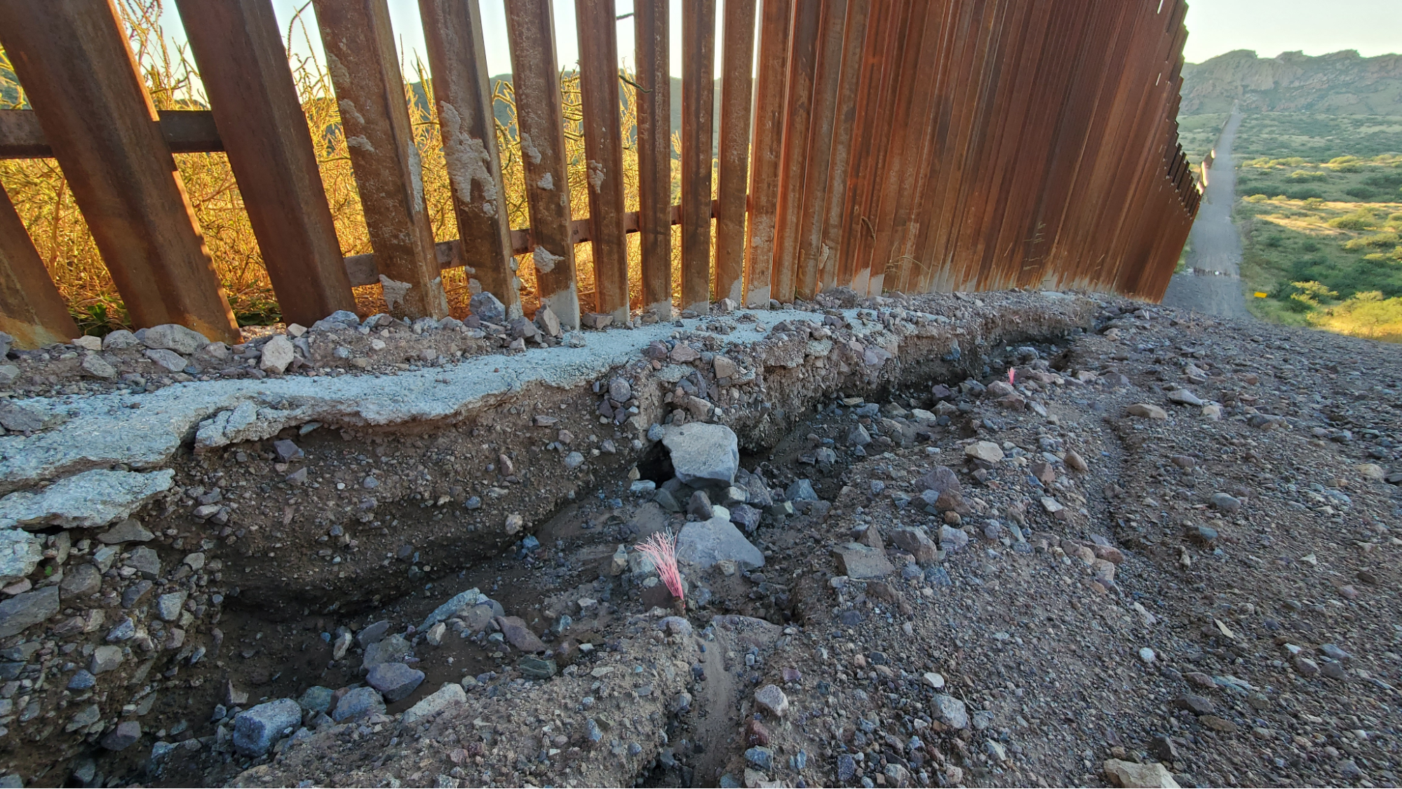 Eroded area at the base of the border wall