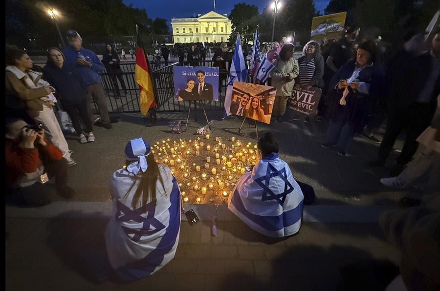 People gather at a memorial for the two Israeli Embassy staffers that were killed.
