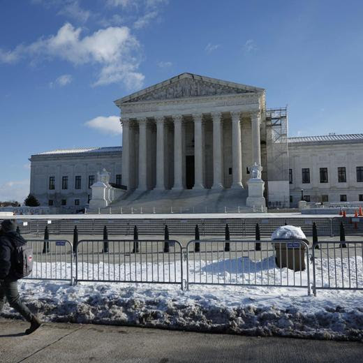 A man walks past the US Supreme Court in Washington, DC, on January 8, 2025. US President-elect Donald Trump asked the Supreme Court on January 8, 2025 to block his sentencing this week for covering up hush money payments to a porn star while he appeals his conviction. Trump made the eleventh-hour plea for a suspension of the criminal proceedings to the nation's highest court after a New York State appeals court dismissed his effort to have the hearing delayed. He is scheduled to be sentenced on January 10. (Photo by Ting Shen / AFP)