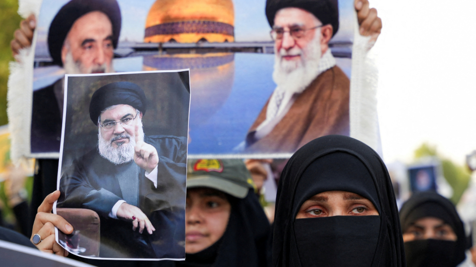 A woman holds a picture of Lebanons Hezbollah Chief Hassan Nasrallah who was killed by an Israeli airstrike in Beirut