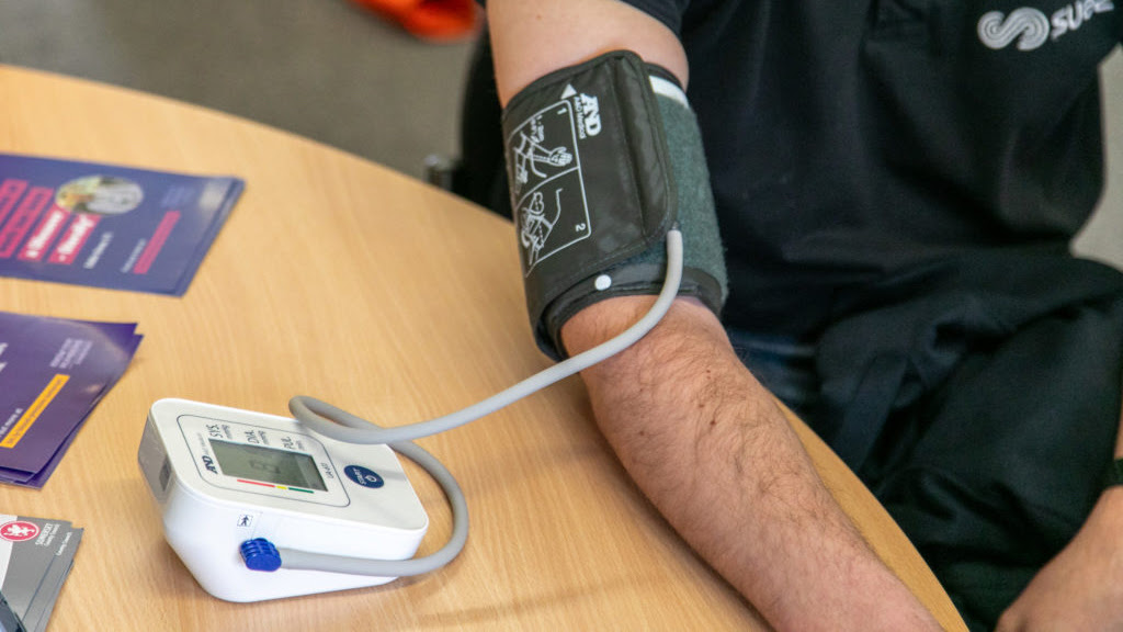 A SUEZ member of staff having his blood pressure taken.