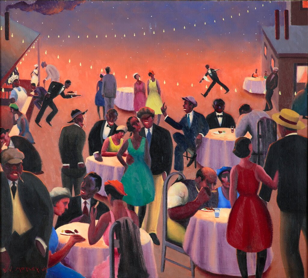 The painting “Barbecue” by Archibald J. Motley. A group of Black men and women celebrate, some sitting at tables with white tablecloths, others standing around. Lights are strung above them. A house is at the right of the frame; two cooks stand behind a counter at the left of the frame. 