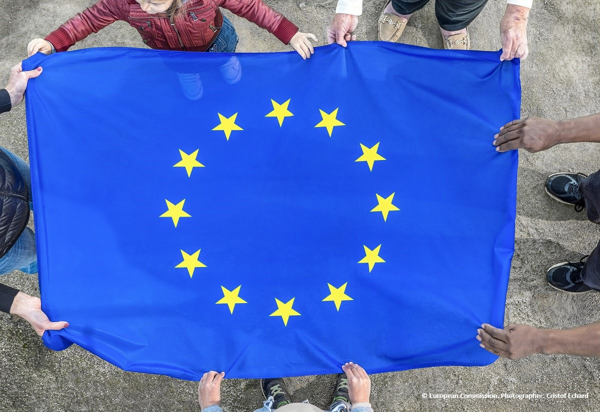 people holding the EU flag