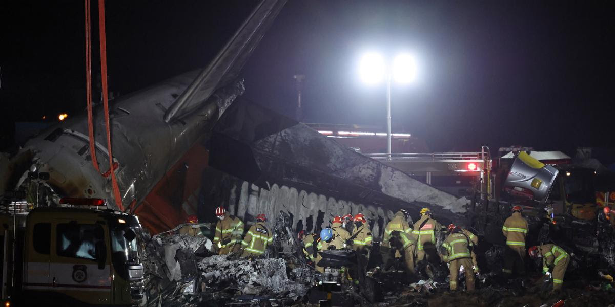 epaselect epa11797310 Firefighters work near the wreckage of a Jeju Air aircraft at Muan International Airport in Muan, South Jeolla Province, South Korea, 29 December 2024. According to the South Korea National Fire Agency (NFA), a passenger jet carrying 181 people erupted in flames after going off the runway at an airport in South Korea's southwestern county of Muan on 29 December, leaving at least 176 people dead and 3 missing, as two crew members survived. EPA/HAN MYUNG-GU