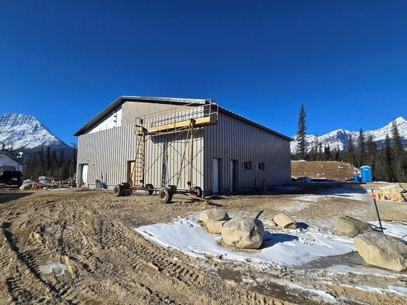 An image of building, with most of the siding installed. 