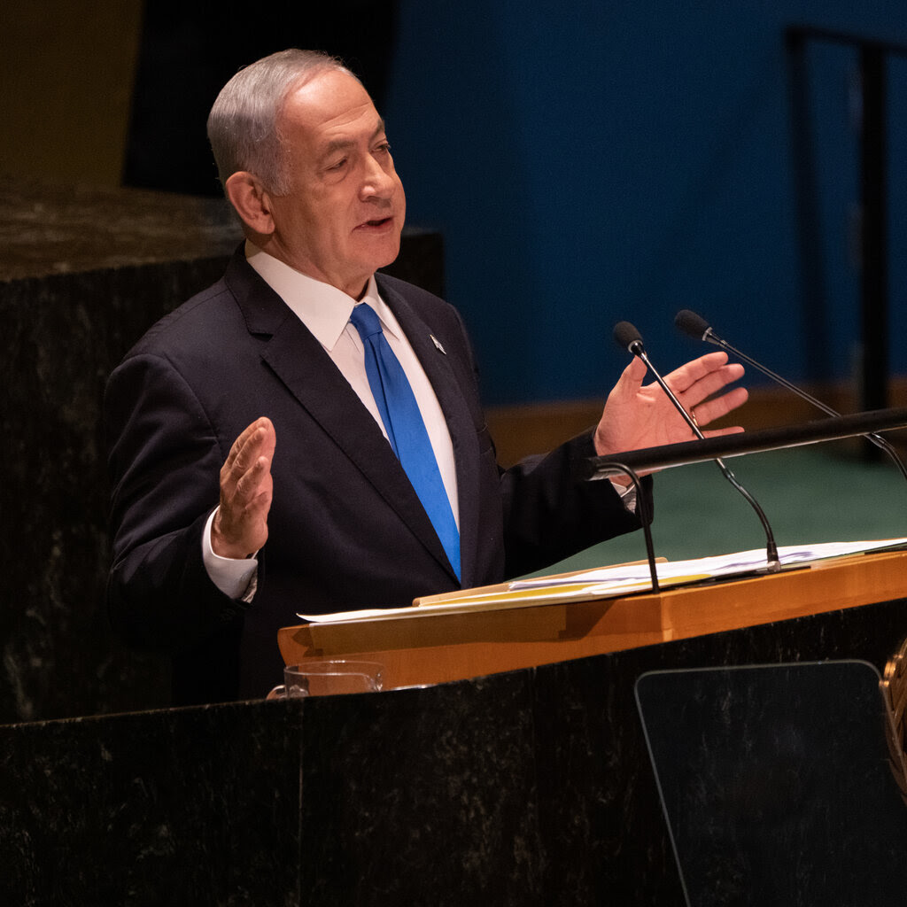 Benjamin Netanyahu speaking at a lectern.