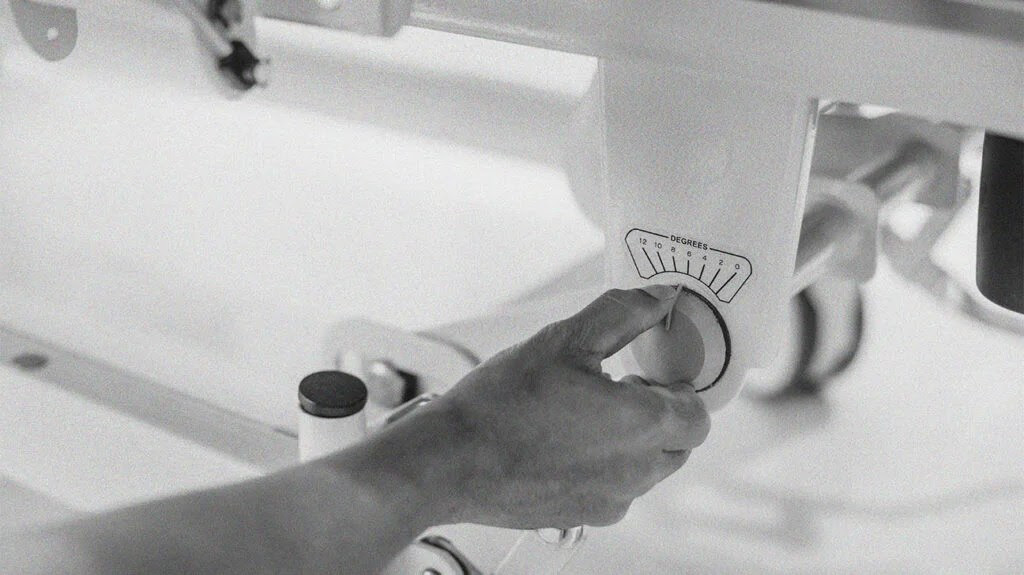 Closeup of a person adjusting a bed.