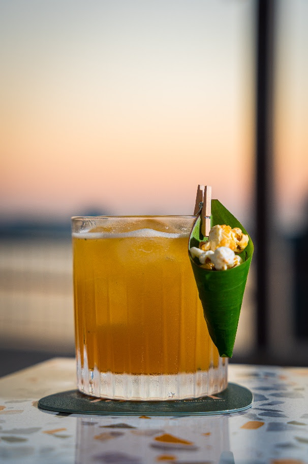 A glass of liquid with a cone of popcorn on itAI-generated content may be incorrect. A glass of liquid with a cone of popcorn on itAI-generated content may be incorrect.
