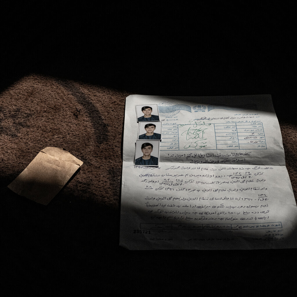 A government document and three passport photos of Salahuddin, a young man.