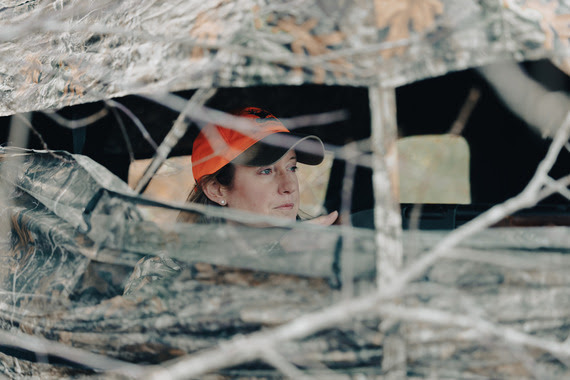 A woman in camouflage hunting deer.