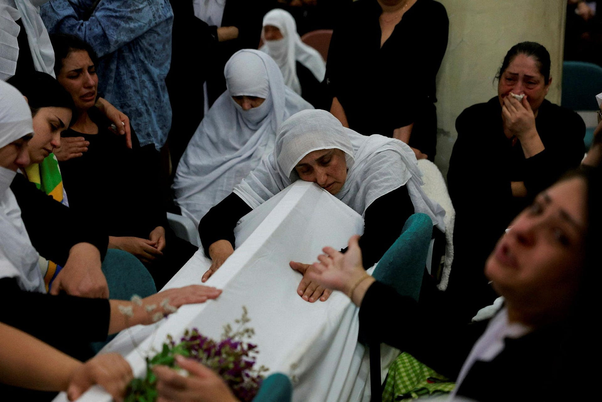 Families whose children were killed at a soccer pitch by a rocket launched across Lebanon's border with Israel at the funeral in Majdal Shams, Sunday.