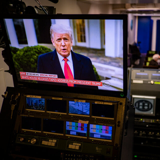 Donald J. Trump on a screen with a chyron that says “Live CBS News Special Report. White House releases taped address from President Trump.” In the background is the White House briefing room, with chairs, a lectern and an American flag.