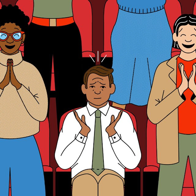 An illustration shows a man applauding while seated, surrounded by people on their feet who are clapping their hands more enthusiastically.