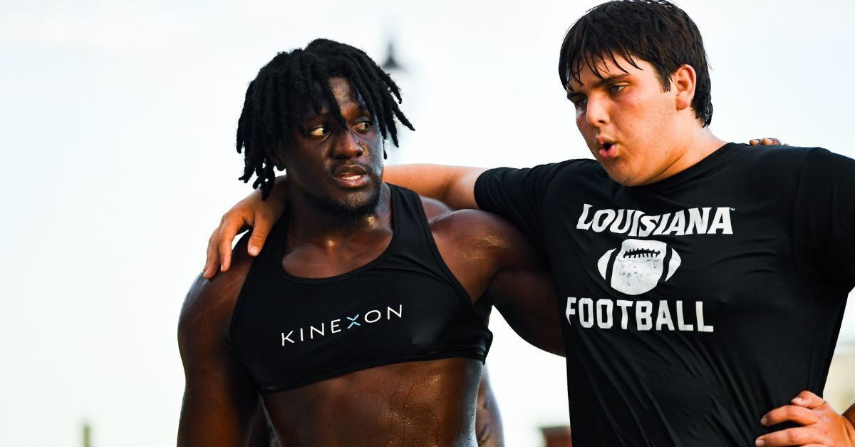 University of Louisiana football players at practice while wearing a KINEXON Sports vest.