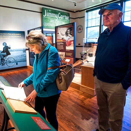 Nancy Shelbourne and Dave Shelbourne, of Indianapolis, Ind., visit the Jimmy Carter Visitor center in the old Plains High School building in Plains, Ga., on Monday December 30, 2024. Former President Jimmy Carter died on Sunday December 29, 2024.