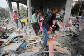 The lifeless body of a Palestinian is pulled from the rubble as Palestinian residents of the area carry out search and rescue works in the building heavily damaged after Israeli attack over an apartment building belonging to the Matir family in the Nuseirat Refugee Camp in Deir Al Balah