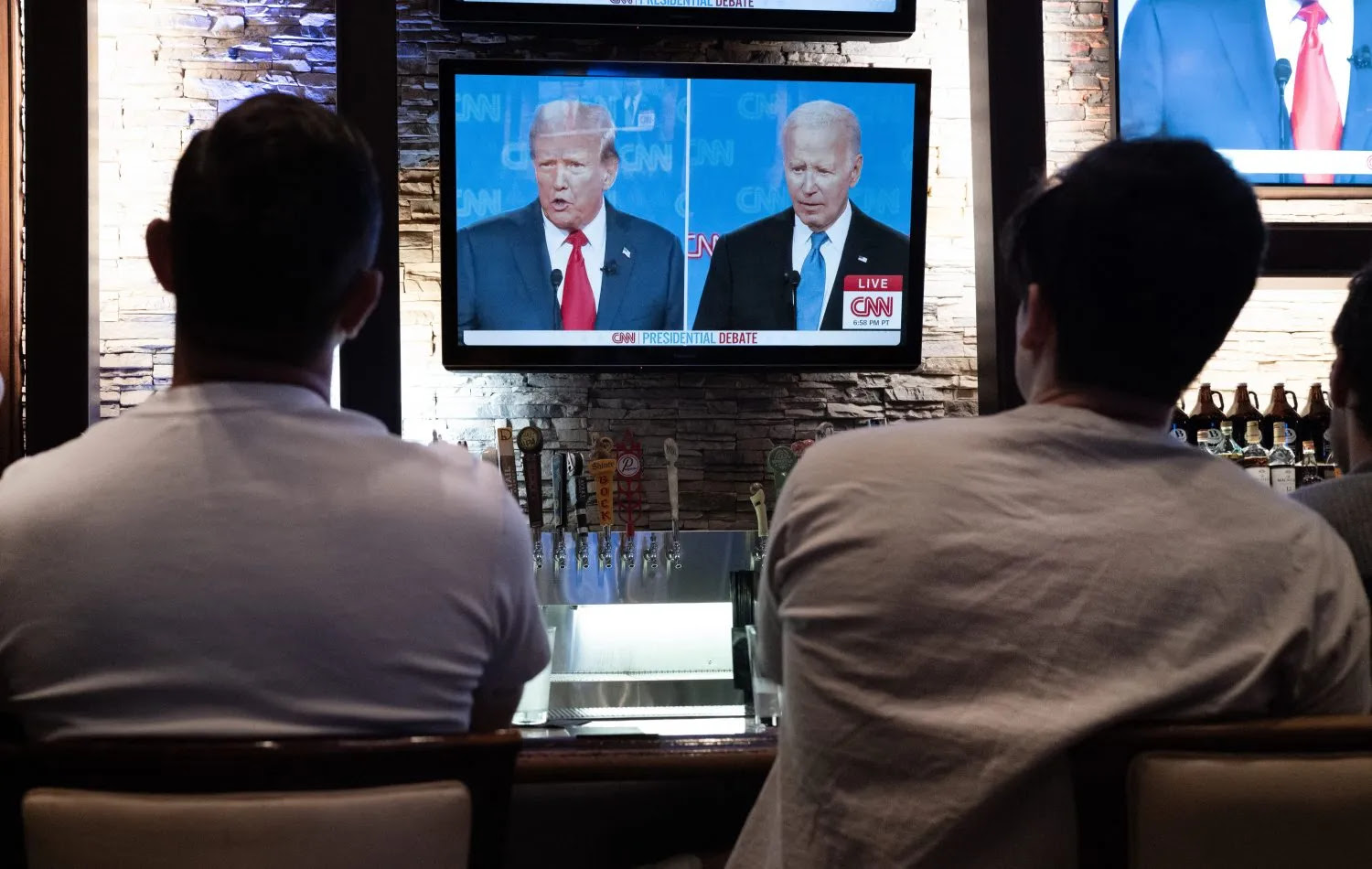 People watch a live television debate between U.S. President Joe Biden and former President Donald Trump, in Chicago on June 27.