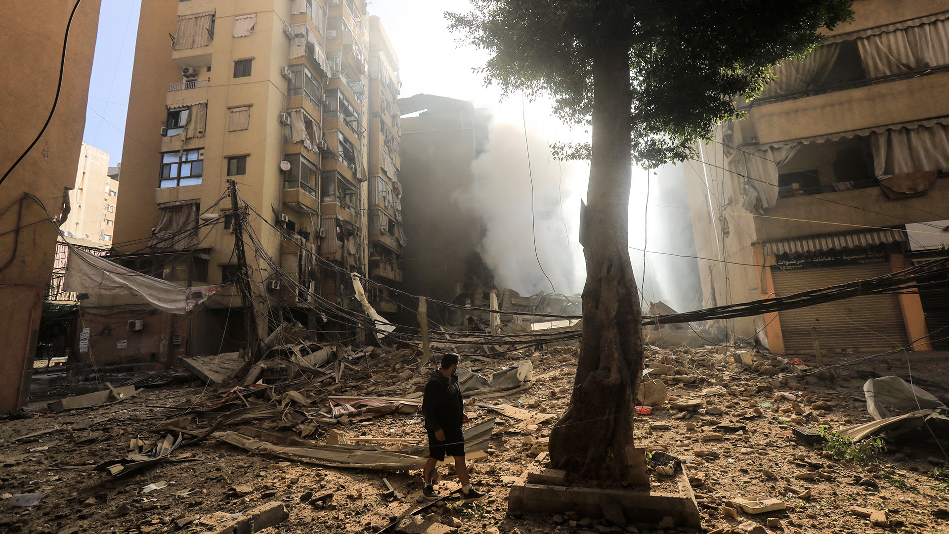 A resident walks amid the devastation following an overnight Israeli airstrike that targeted the neighborhood of Haret Hreik in Beirut's southern suburbs on October 3, 2024 (Photo by AFP) (Photo by -/AFP via Getty Images).