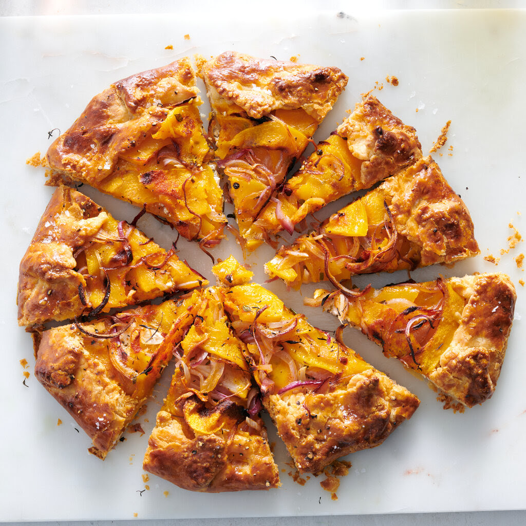 A butternut squash galette on a white table.