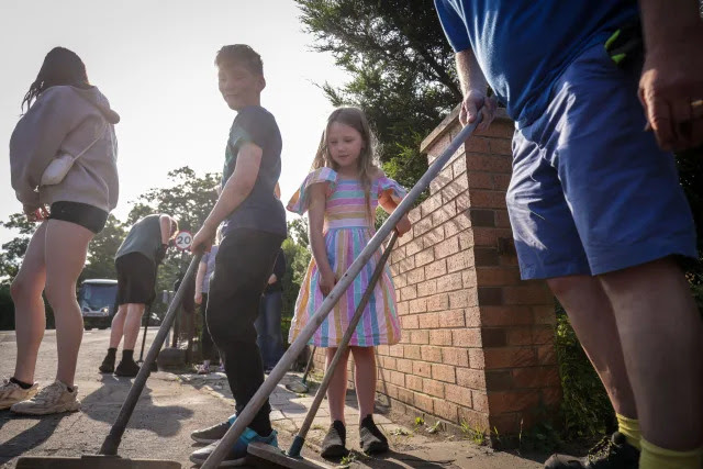 ***PARENTAL PERMISSION GRANTED*** Volunteers sweep Sussex Road in Southport, Merseyside, after police officers suffered serious injuries when bricks, stones and bottles were thrown and cars were set alight during violent protests following a vigil for three girls killed in a knife attack at a Taylor Swift-themed holiday club on Monday. Picture date: Wednesday July 31, 2024.