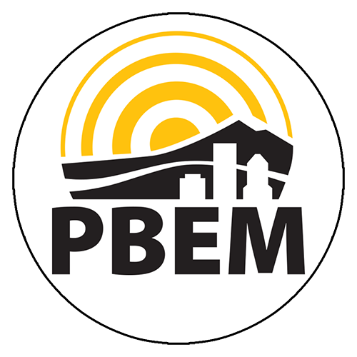 Logo for the Portland Bureau of Emergency Management: Buildings and a mountain with yellow rings of sunlight over them.