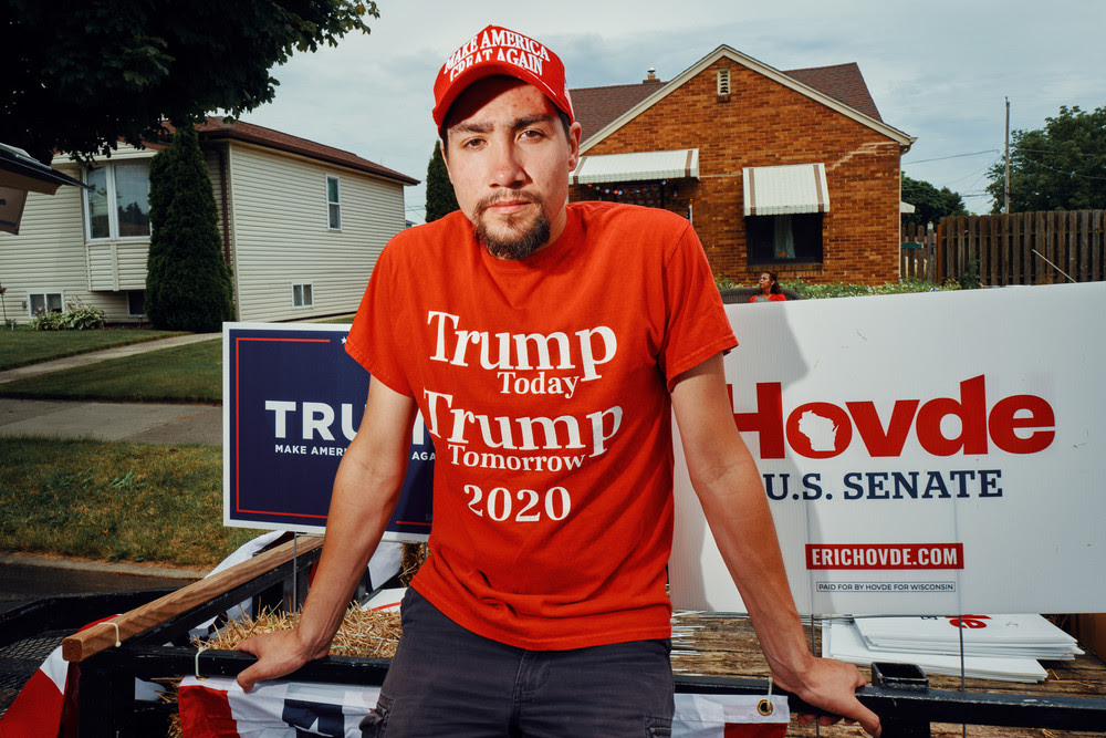 Hilario Deleon stands for a portrait in front of Donald Trump and Eric Hovde campaign signs.