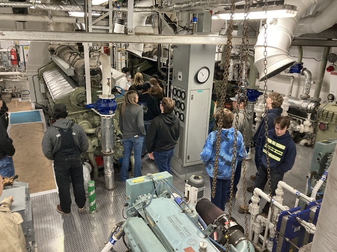 High school students learn about job opportunities with us inside the engine room of Kaleetan, while docked at our Eagle Harbor Maintenance Facility. 