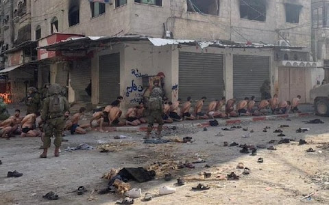 IDF strip Palestinian men and parade them through square once used by Hamas
