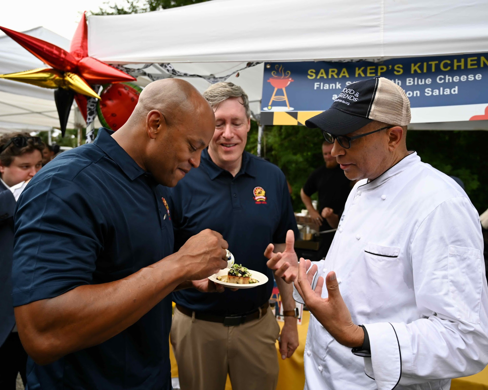 Governor Moore eating at Buy Local Cookout