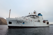 Research Vessel Oscar Dyson leaving Dutch Harbor on a cloudy day with calm water.